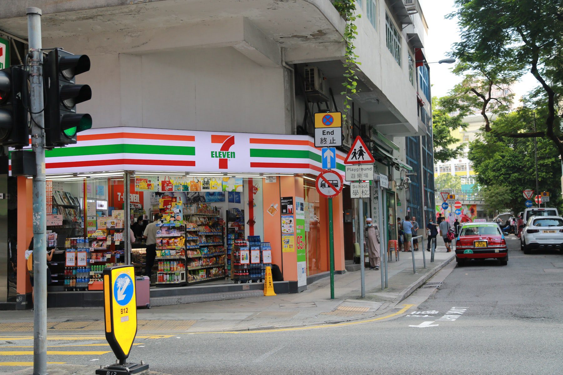 A 7 Eleven convenience store in an urban area from the street. 