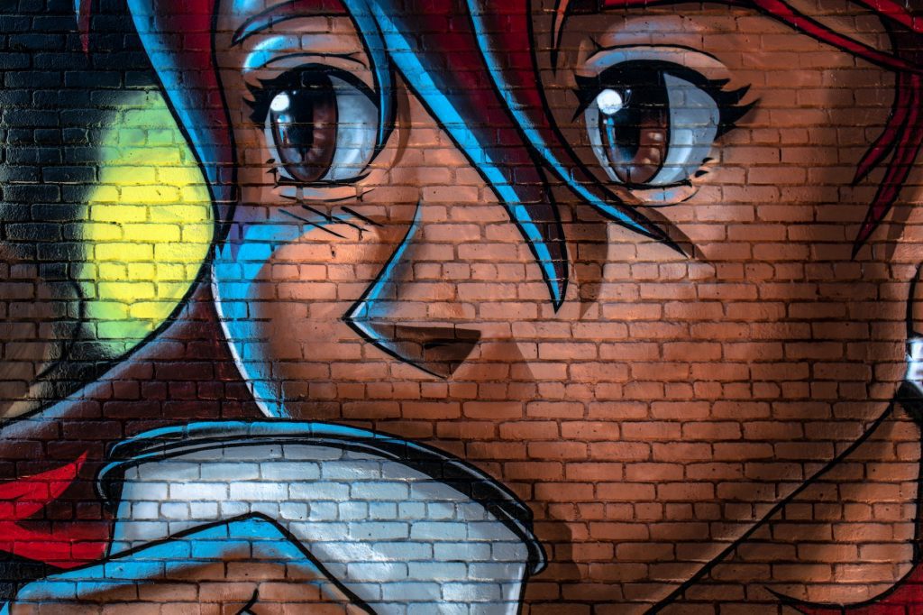 anime style graffiti on brick wall