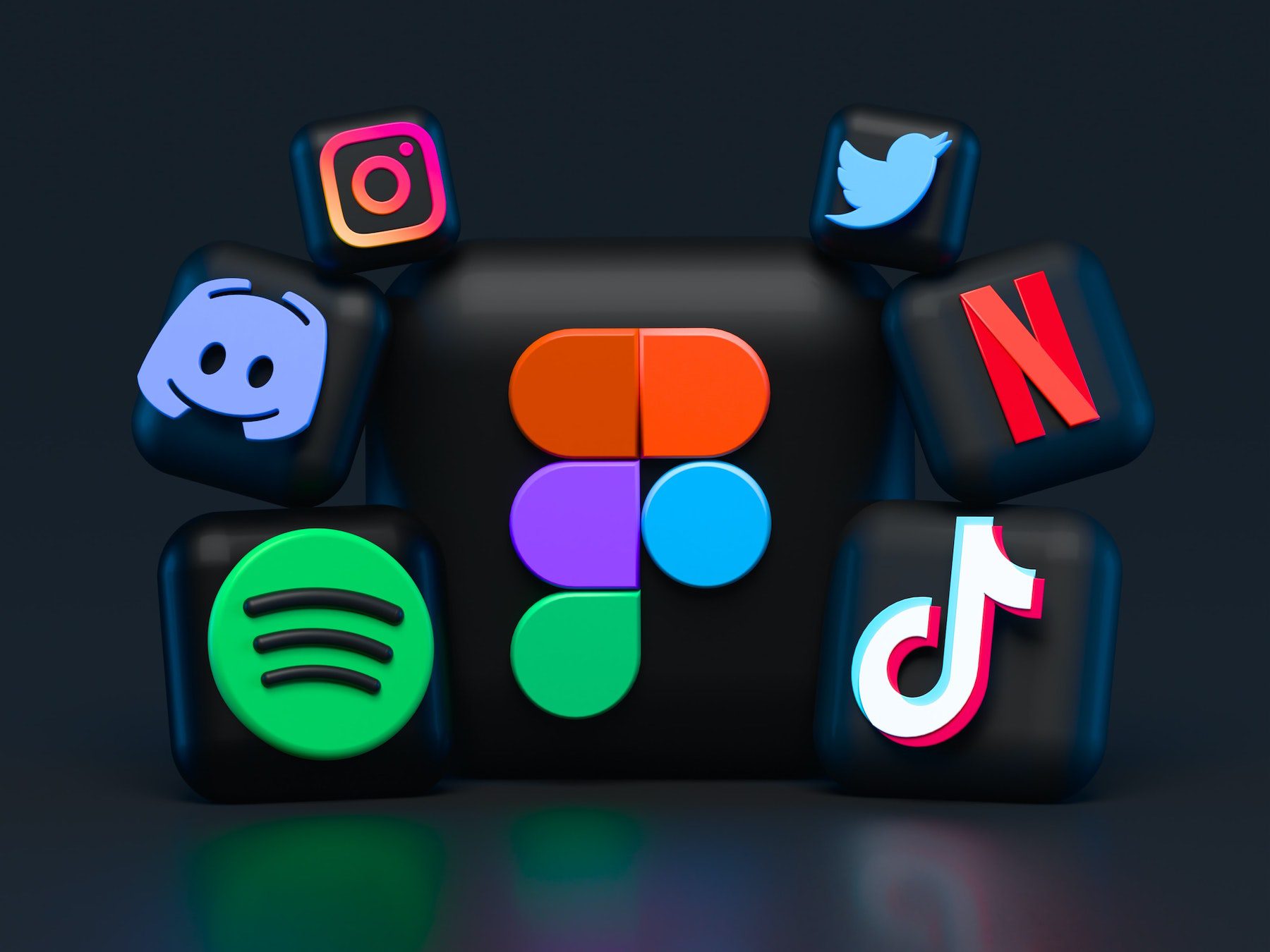 Social media icons glowing neon colors on a black background.