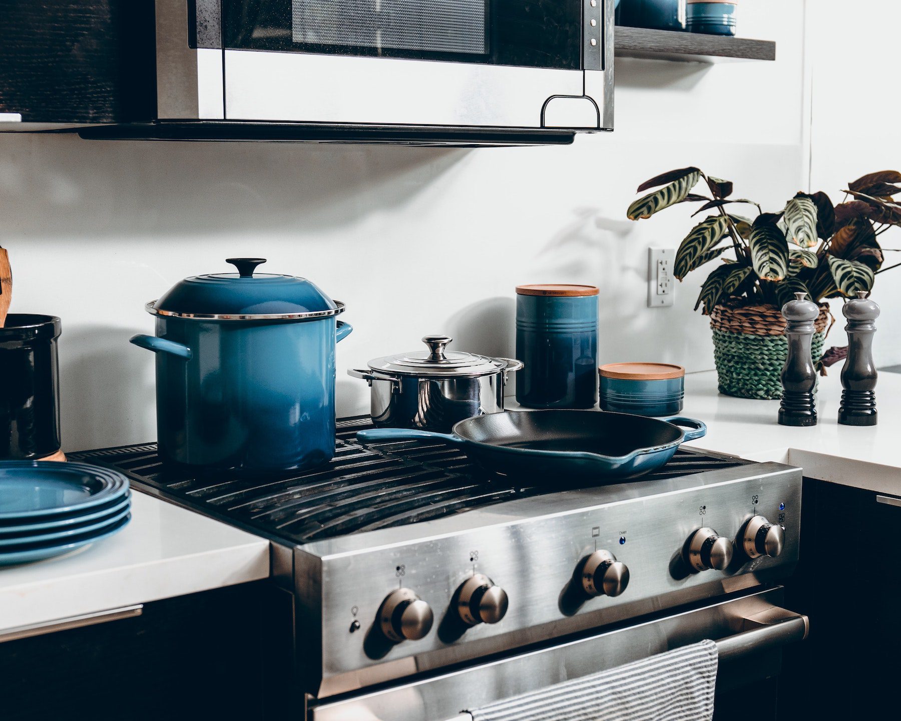 A clean modern kitchen with blue ombre cookware.