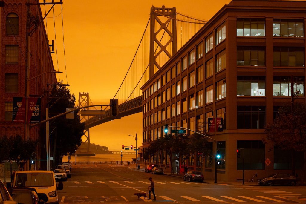 Apocalypse landscape, urban deserted street with bridge and ominous orange sky.