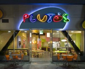 Exterior shot of a Pluto's takeout and dine-in location in California.