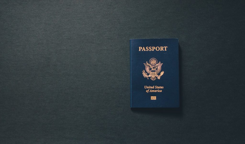 Passport on a dark gray tabletop.