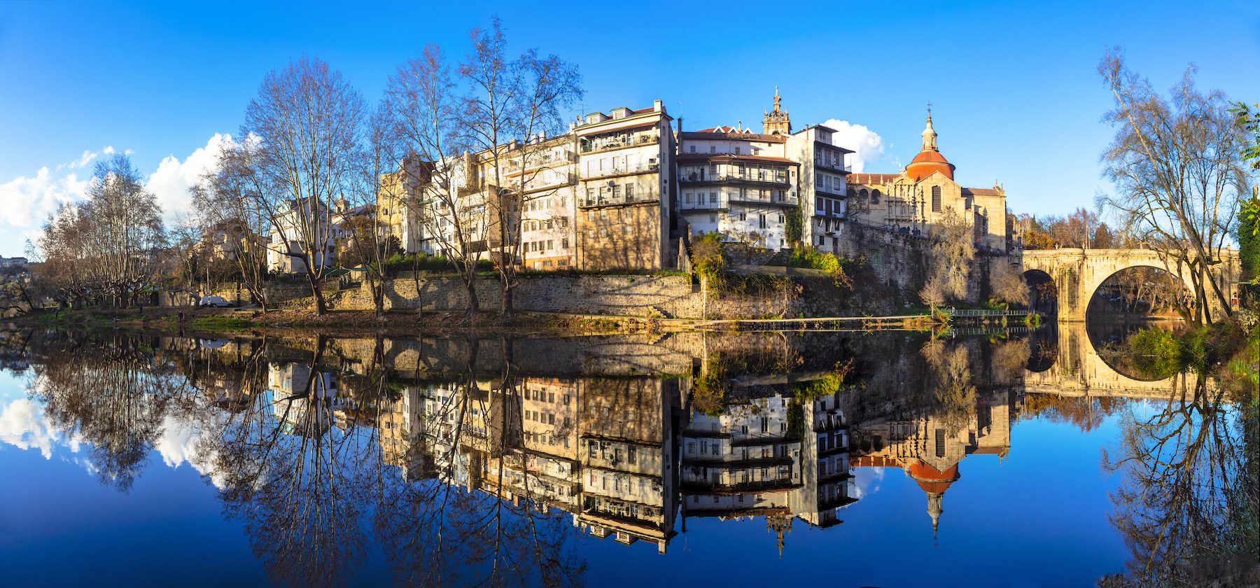 The Amarante is reflected on a complpetely still lake in Fall or Winter in Portugal