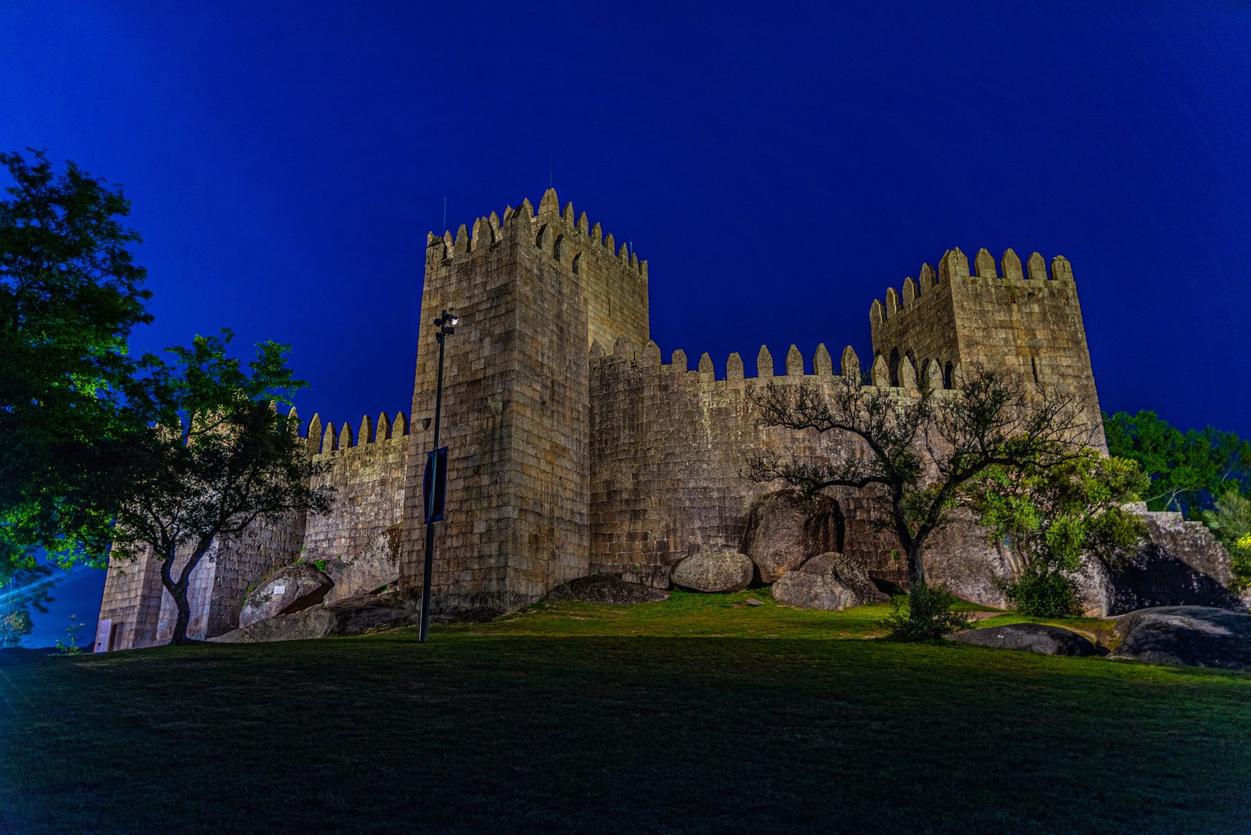 Guimaraes castle in Portugal against a deep blue sky