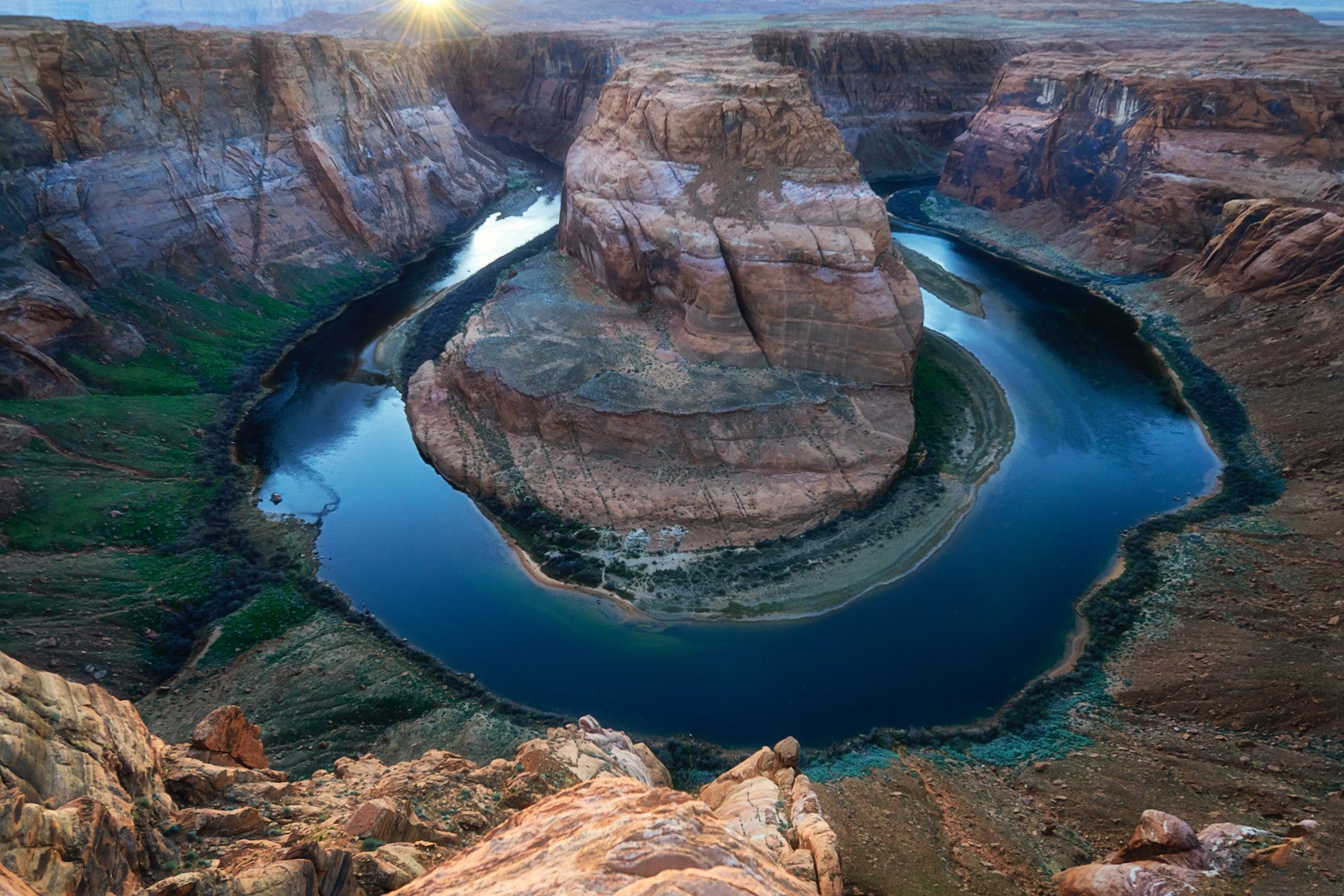 the well known river in a valley surrounded by towering red rock cliff at Horseshoe Bend, Arizona