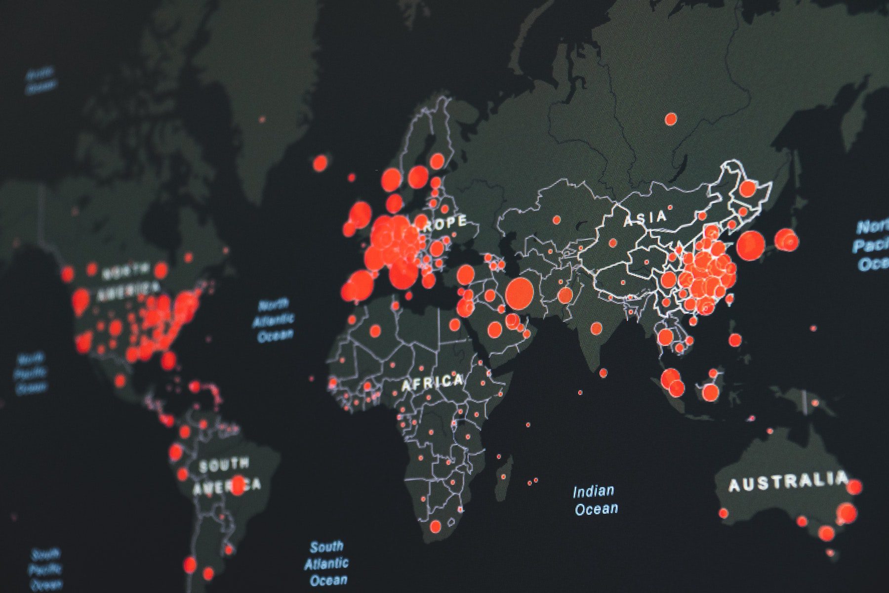 CDC illuminated map showing an outbreak across continents in black and red. 