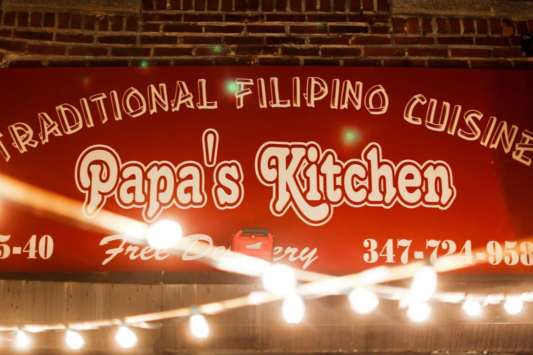 Sign in Papa's Kitchen, reading "Traditional Filipino Cuisine."
