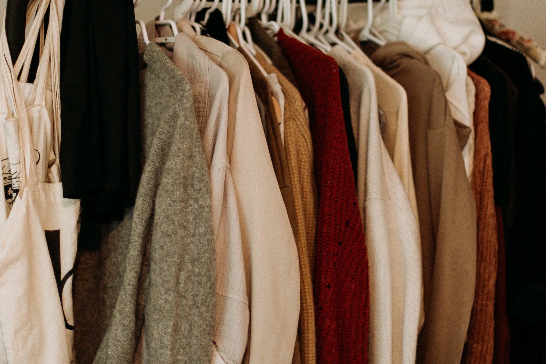 A closet filled with coats and sweaters