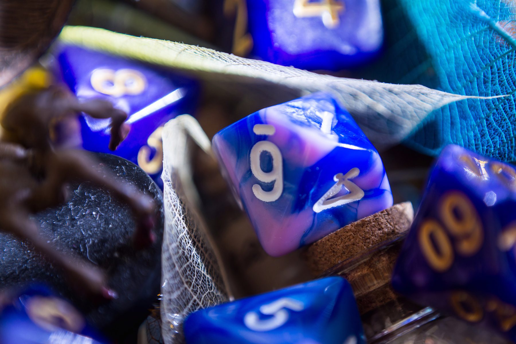 A close-up blurred image of an 8-sided among others dice that is used for the popular dungeons and dragons game