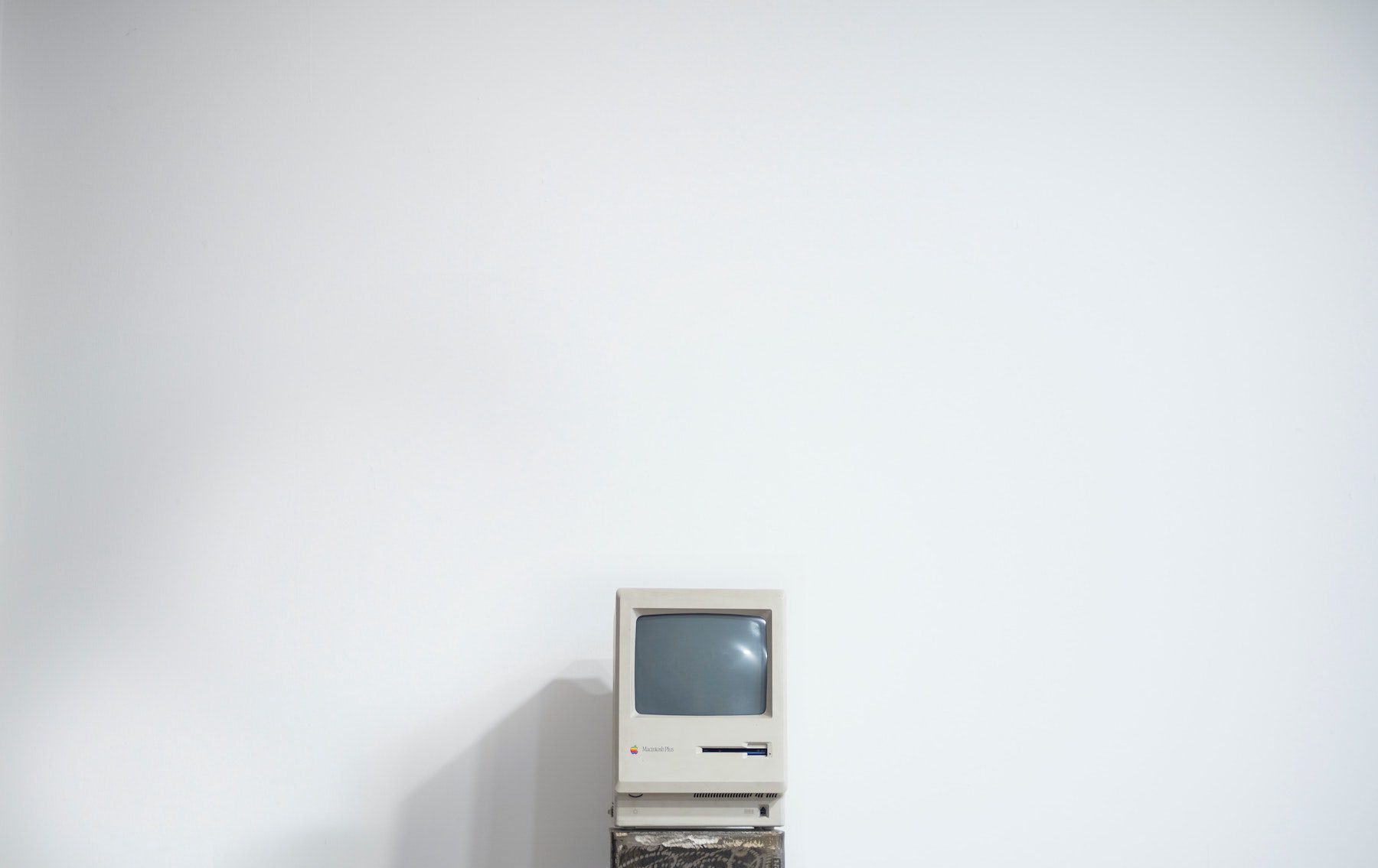 Vintage computer against a plain white wall. 