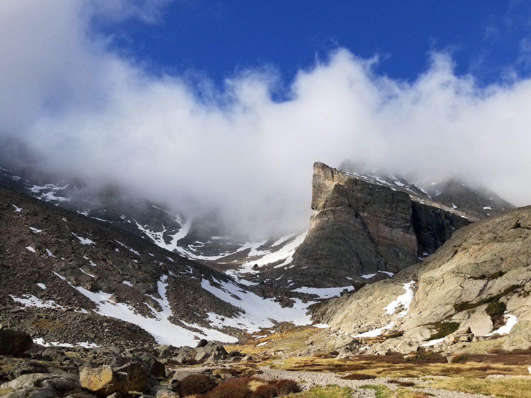 Bright blue sky and white clouds over the Ship's Prow of Long's Peak at Rocky Mountain National Park in Colorado.