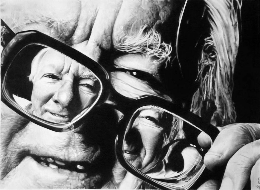 Ray Bradbury holding glasses off face to reveal a second smiling self-portrait in the lenses, black and white.