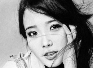 Korean pop star IU with head propped in hand, black and white.