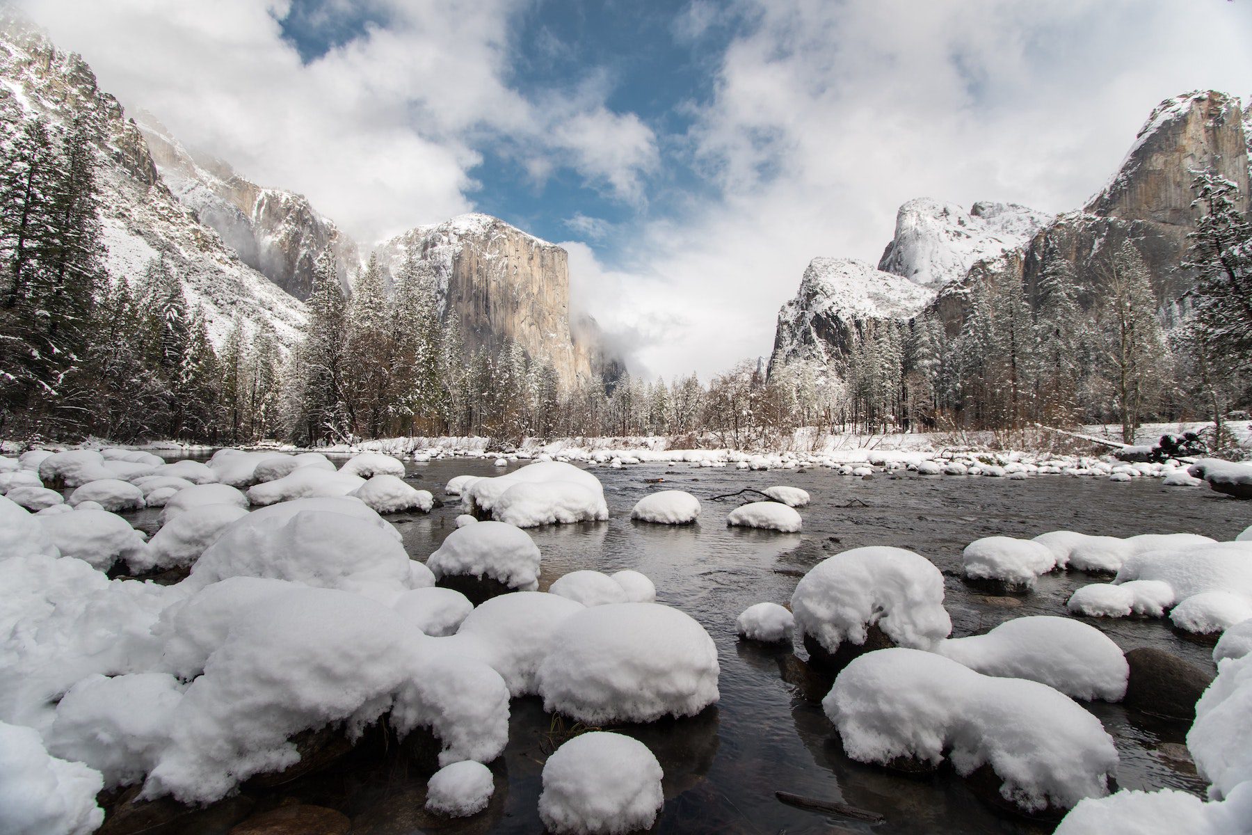 Snow-covered rocks in a valley or creek at Yosemite National Park. 