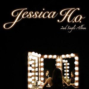 Artwork for Jessica Ho Rebirth album featuring the star staring into vanity lights and mirrors. 
