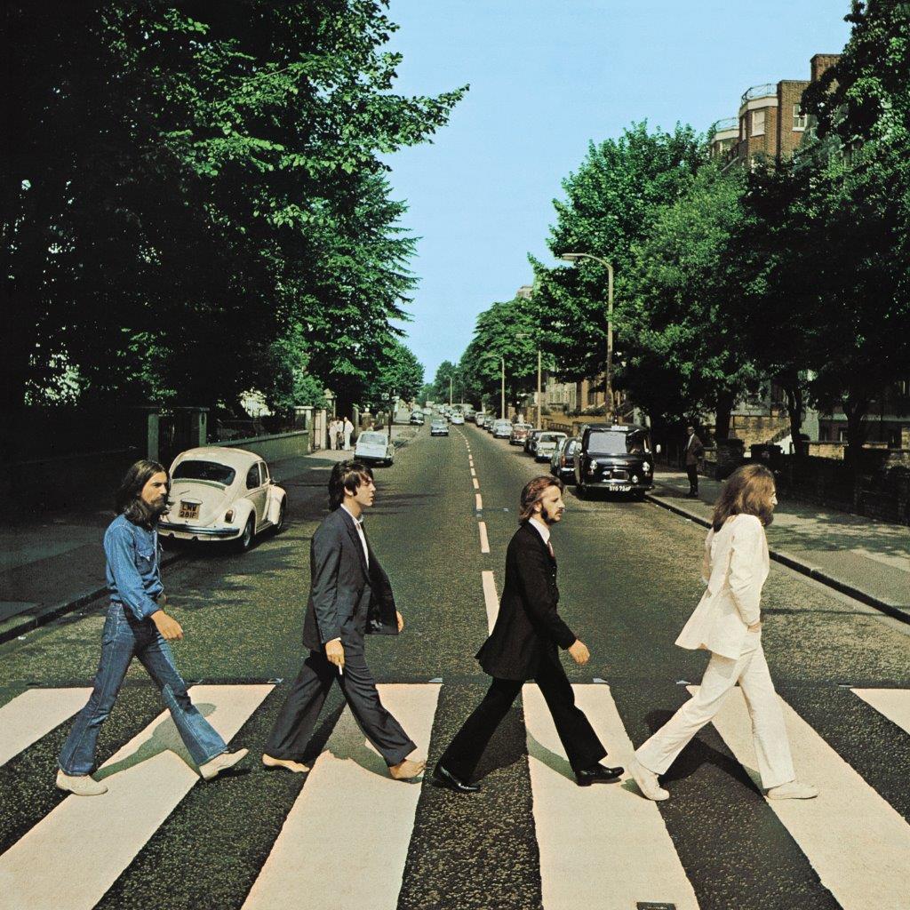 "Abbey Road" by The Beatles album cover. Members of the band are walking across a street in a crosswalk