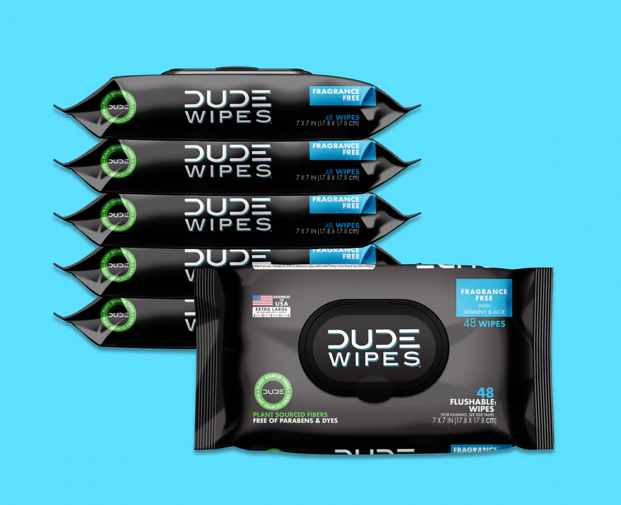 6-Pack of "Dude Wipes" flushable wipes against a teal background